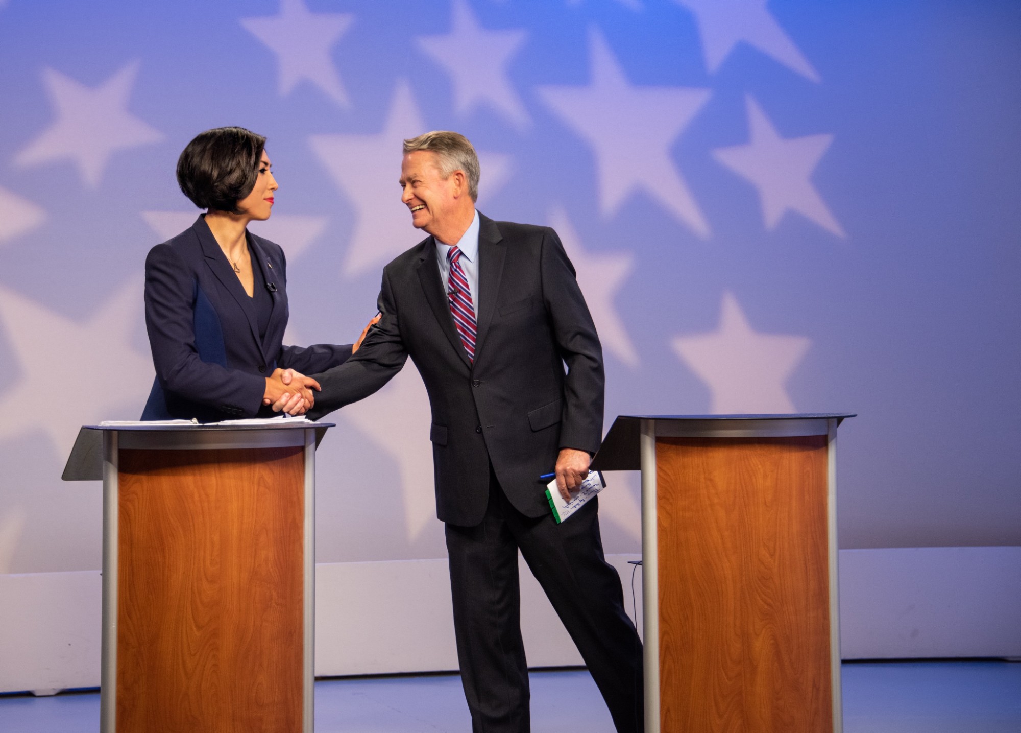 Paulette Jordan shaking hands with her opponent after the debate