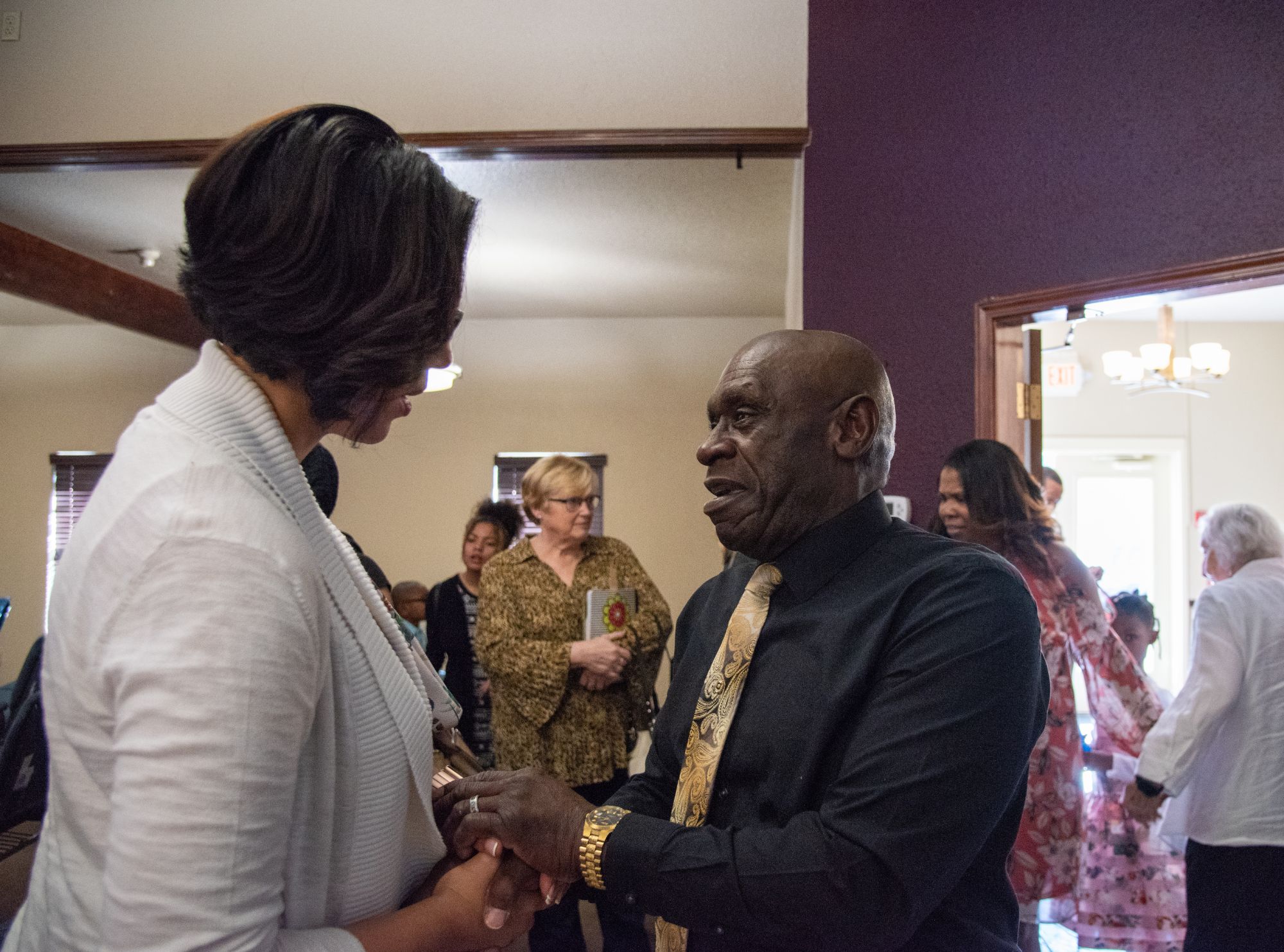 Paulette Jordan greeting an elder at a community gathering