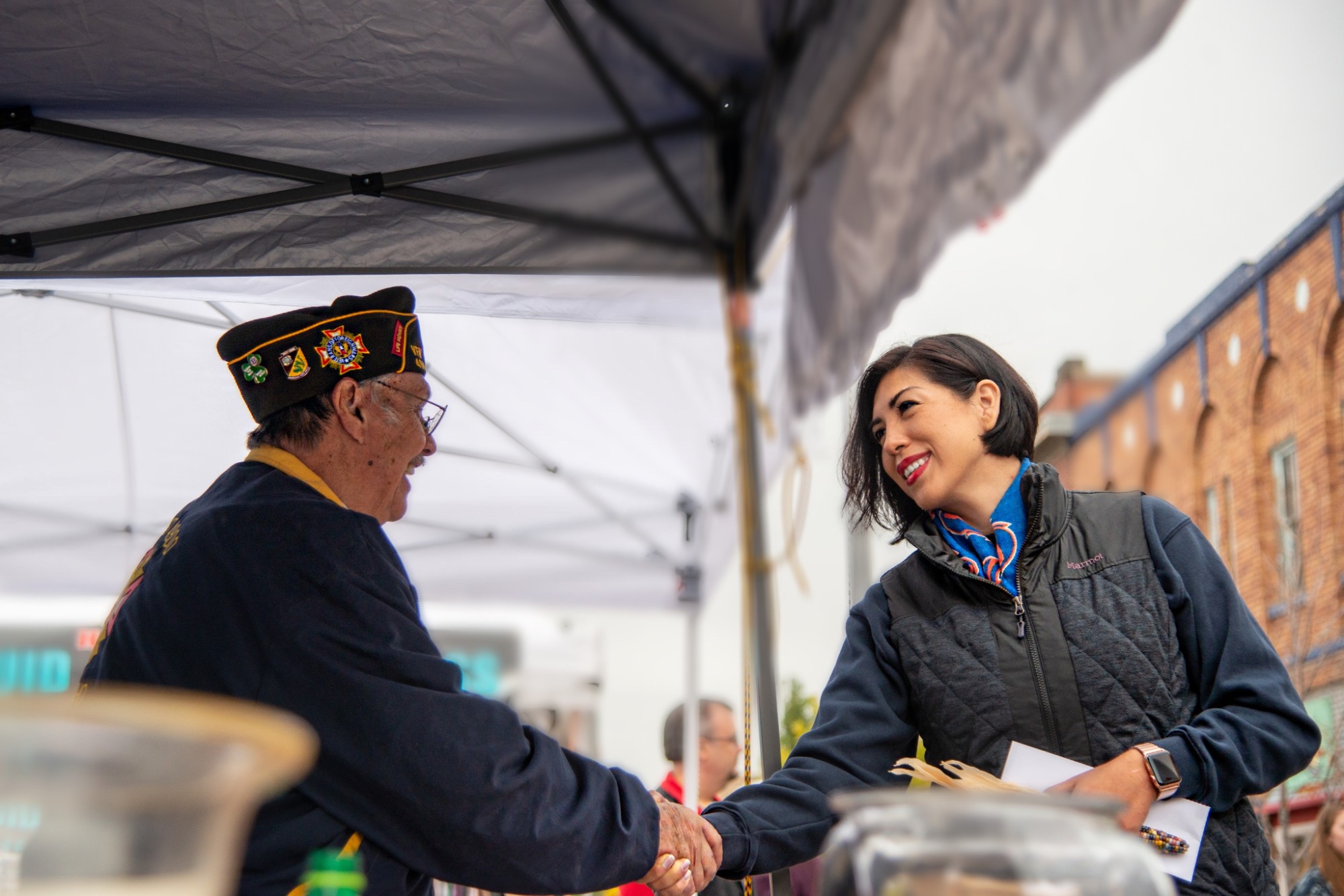 Paulette Jordan shaking hands with a veteran